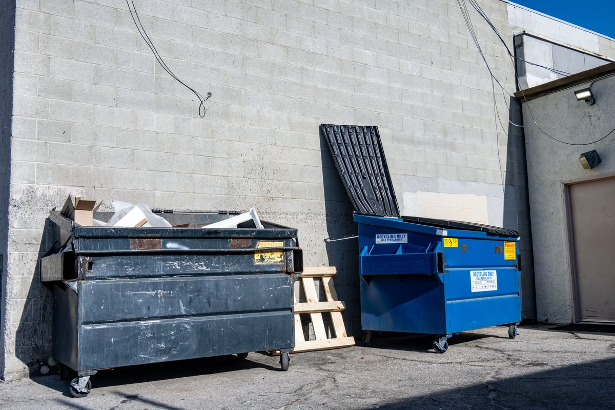 Dumpsters lined up in an alley